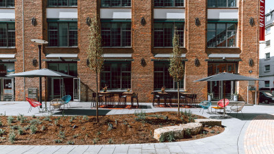 Outdoor area of GOOSE Eventspace with open parasols at summer party venue Frankfurt