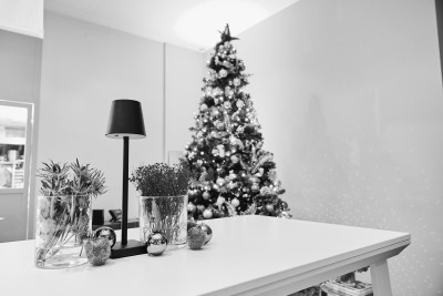 Weihnachtliche Tischdekoration mit Weihnachtsbaum im Hintergrund